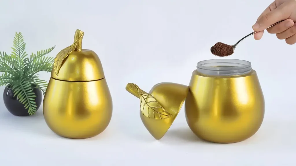 دو ظرف دکوری آشپزخانه به شکل گلابی طلایی برای نگهداری پودر قهوه و ادویه که با بازیافت شیشه ساخته شده‌اند.