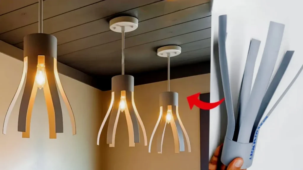 آموزش ساخت لوستر مدرن با لوله PVC خاکستری، چراغ آویز دست ساز با لامپ ادیسونی، ایده کاردستی خلاقانه برای دکوراسیون داخلی، بازیافت لوله پولیکا و تبدیل آن به روشنایی سقفی شیک، مراحل برش و فرم دهی لوله پی وی سی برای ساخت حباب چراغ.