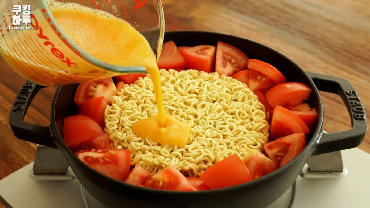 طرز تهیه نودل گوجه فرنگی و تخم مرغ در ماهیتابه، ریختن تخم مرغ هم زده روی نودل فوری و گوجه، غذای فوری با نودل و میگو، رامن هک خوشمزه با سس آنچویی و سیر، ایده شام ۱۰ دقیقهای.